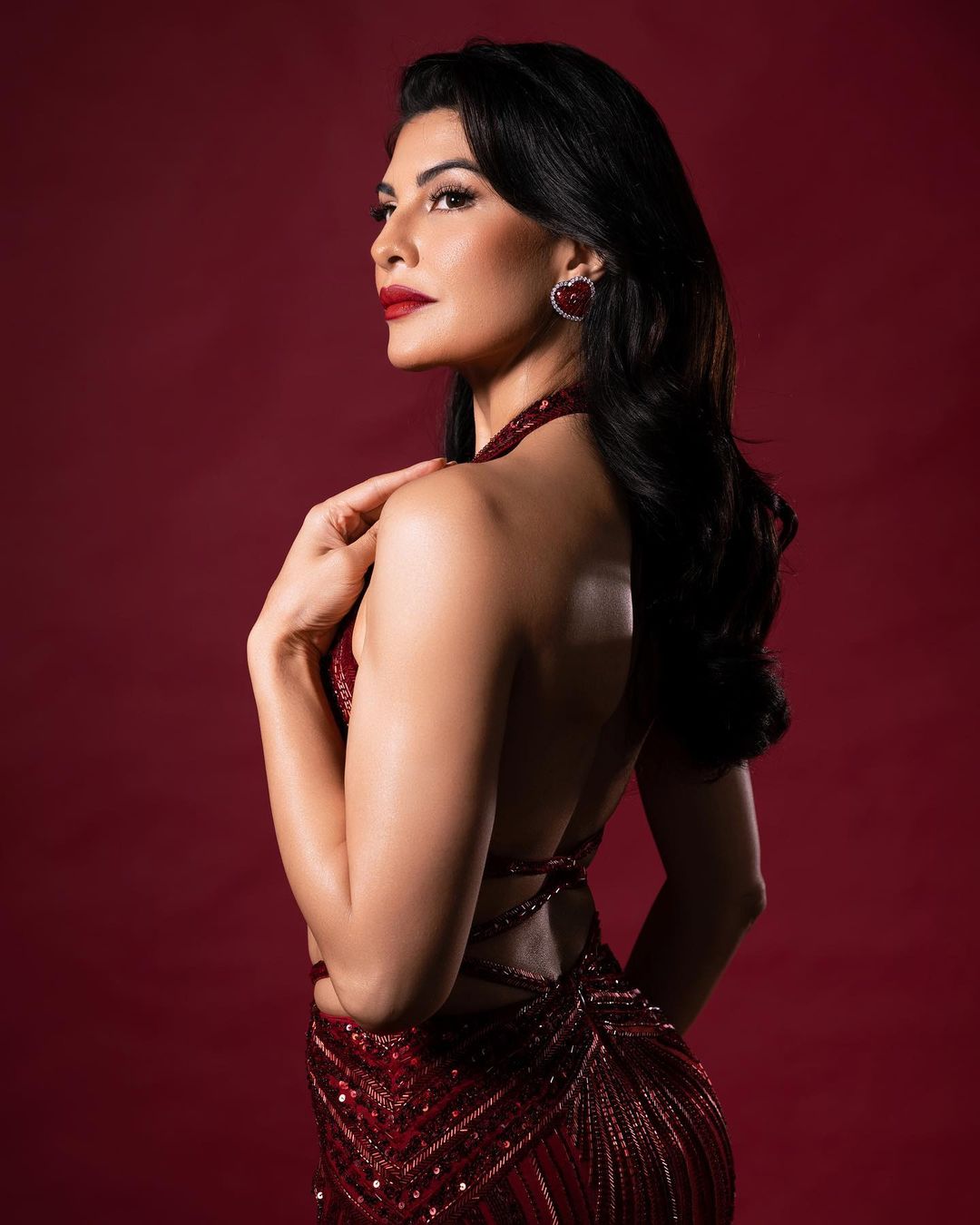 JACQUELINE FERNANDES IN RED CUT OUT GOWN